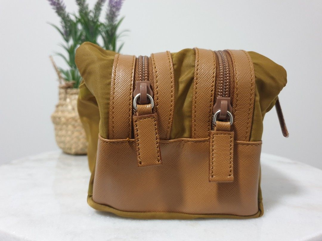 Authentic Prada Re-Nylon and Saffiano Leather Travel Pouch (Category: Bags & Wallets) located in Campbelltown. Submitted by kaye_daddon (Listing ID 1243152237, Image 3). Description: 💎 Sleek, functional design is made of Re-Nylon 💎 Details: ▫️Made in Italy ▫️Color: Tobaco ▫️Zipper closure ▫️Two external zipper pockets ▫️Nylon lining ▫️ Unisex Dimensions: L 14cm x H 11cm × D 26cm Inclusions: ▫️Authenticity certificate card Rating: Very good ▫️Ou