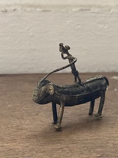 Cute little metal  (brass I think) miniature figurine of an animal and rider