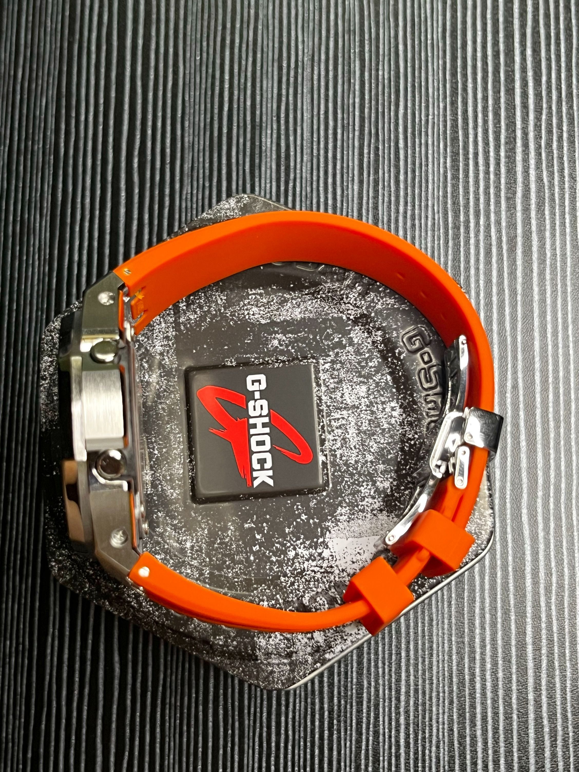 Casio G SHOCK Custom Royal Oak Casio Oak GA 2100 1A4DR Black Dial with Orange Accents Silver Metal Bezel with Orange Rubber strap and Butterfly