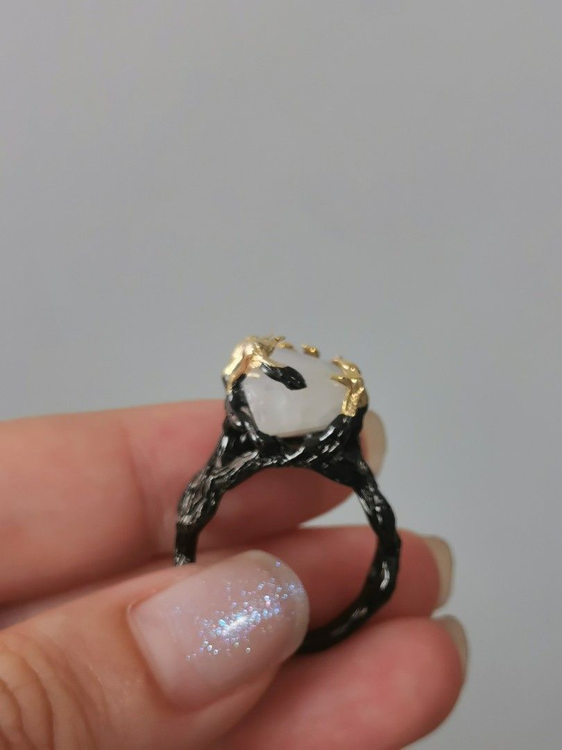 Statement Moonstone Ring (Category: Rings) located in Singapore. Submitted by shopwithtt (Listing ID 1243445198, Image 4). Description: Moonstone ring with blue sheen Plated black and gold Ring size US 6.5 Free smartpac mail.