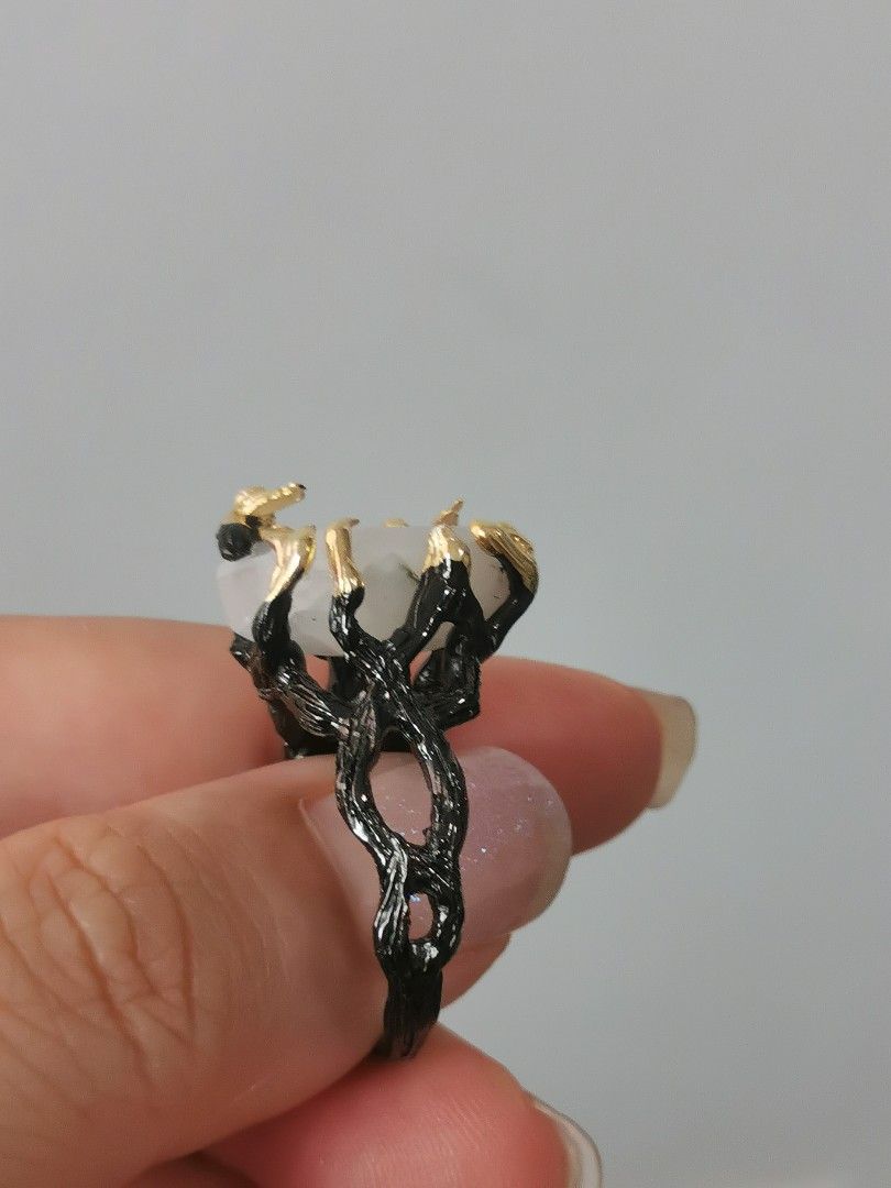 Statement Moonstone Ring (Category: Rings) located in Singapore. Submitted by shopwithtt (Listing ID 1243445198, Image 6). Description: Moonstone ring with blue sheen Plated black and gold Ring size US 6.5 Free smartpac mail.