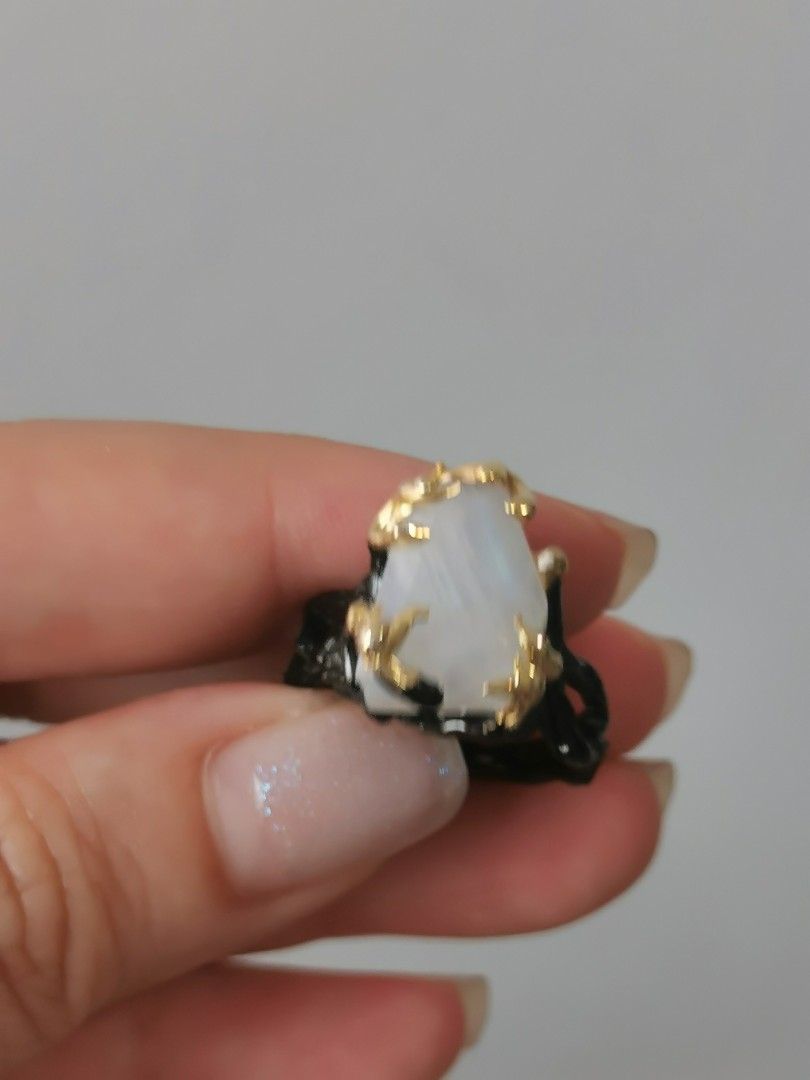 Statement Moonstone Ring (Category: Rings) located in Singapore. Submitted by shopwithtt (Listing ID 1243445198, Image 3). Description: Moonstone ring with blue sheen Plated black and gold Ring size US 6.5 Free smartpac mail.