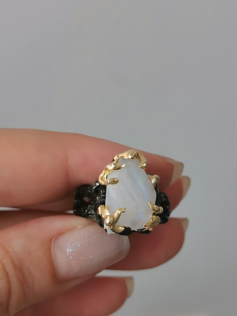Statement Moonstone Ring (Category: Rings) located in Singapore. Submitted by shopwithtt (Listing ID 1243445198, Image 2). Description: Moonstone ring with blue sheen Plated black and gold Ring size US 6.5 Free smartpac mail.