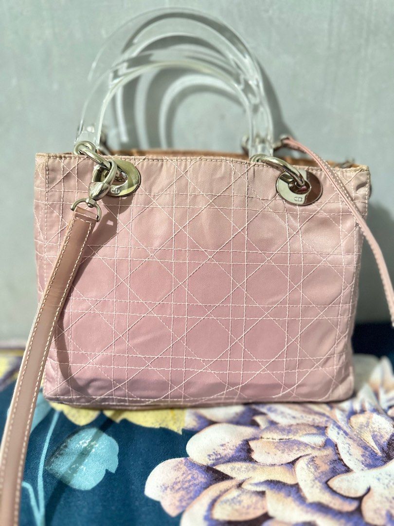 Authentic Christian Dior pink quilted nylon (Category: Luxury Bags & Wallets) located in Makati City. Submitted by pearlclothset (Listing ID 1243615514, Image 1). Description: Vintage lady dior Hand bag. Beautiful rare vintage piece in pink with acrylic clear “crystal” handles. The material is nylon cloth with silver hardware. No damage from inside and outside except for the strap. It’s in a very good condition considering its age. Serial number 
