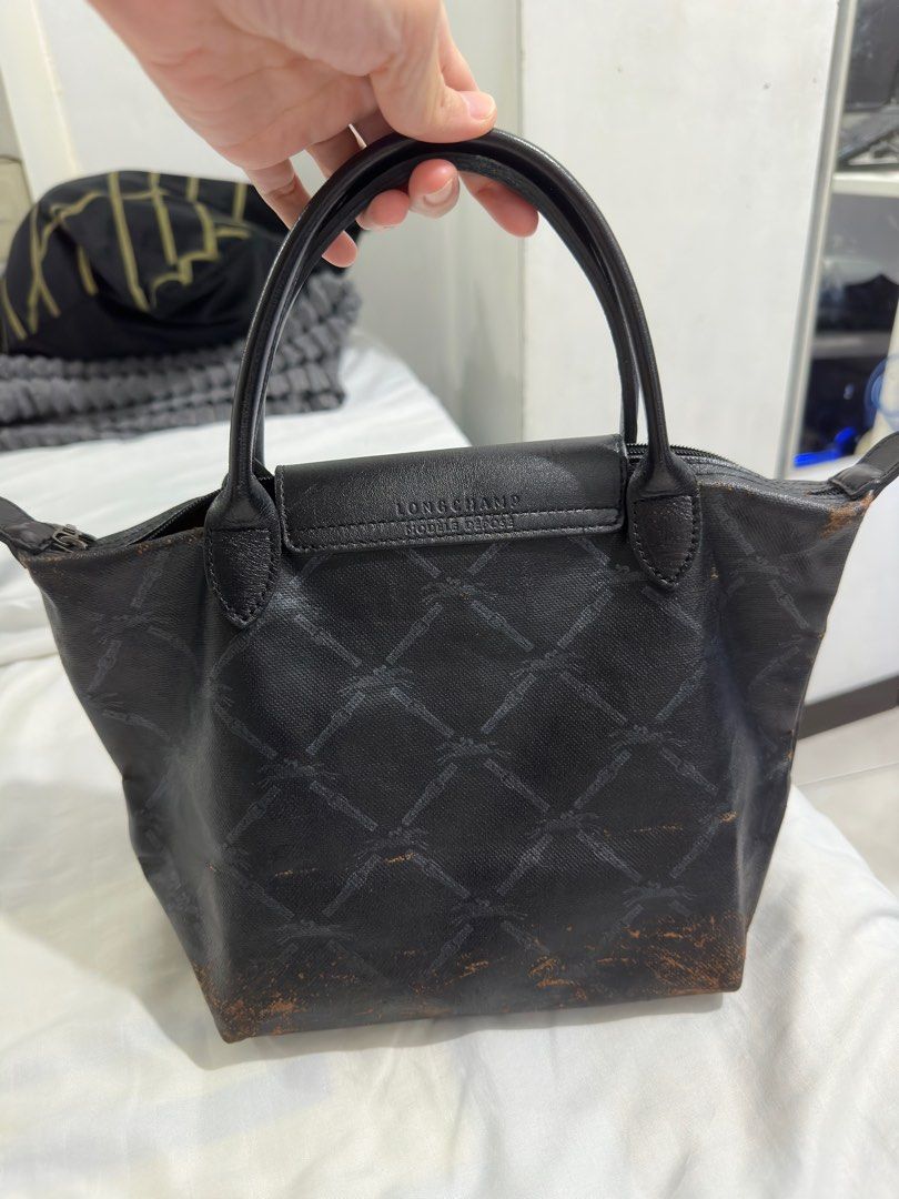 Original Longchamp Small Short handle Black Monogram with flaw (Category: Luxury Bags & Wallets) located in Makati City. Submitted by Bulats (Listing ID 1243847373, Image 2). Description: Bawal sa maarte, peeling but you can recolor. Or use as is. Ok pa naman siya. Loc Montojo makati.