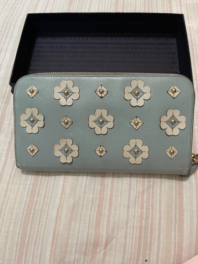 PRADA CONTINENTAL WALLET (Category: Luxury Bags & Wallets) located in Paranaque City. Submitted by msjam63 (Listing ID 1243713385, Image 3). Description: Authentic PRADA Made in Italy Powder blue Very good used condition Has some slight dirt in coins compartment Lampo zip With serial as in photo With Made in Italy tag With Prada box only Sold as is.