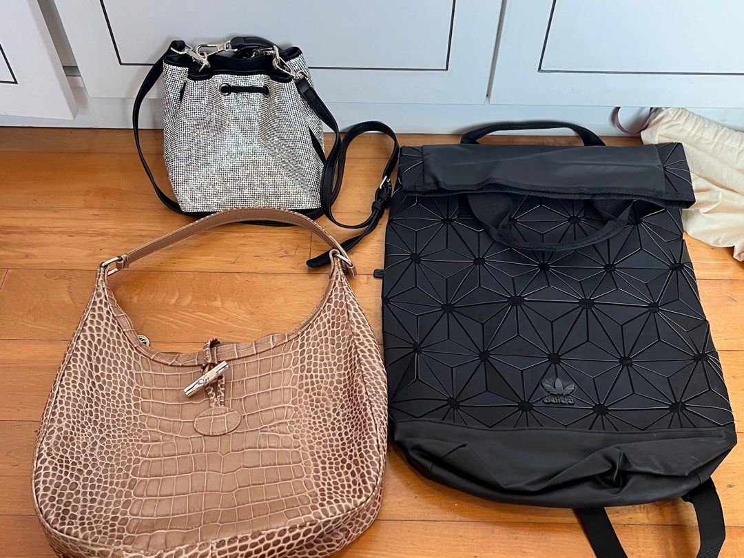 brand new and preloved luxury/ branded bags jim thompson silver shoulder bag, agnes b clutch, adidas black backpack, longchamp y2k brown and striped pink bag, marc jacobs/ mandarina duck/ ted baker cross body sling bags, card holder (Category: Bags & Wallets) located in Singapore. Submitted by honeypegasus (Listing ID 1243913925, Image 2). Description: 2nd pic: - boutique silver sling bag, BNIP $20 - adidas miyake roll top black backpack, BNIP $5