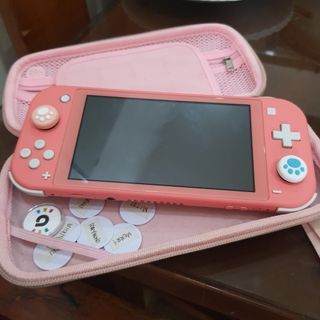 NINTENDO SWITCH LITE IN CORAL PINK COLOR! Free amiibos, case, screen protector, and free ANIMAL CROSSING GAME with case!