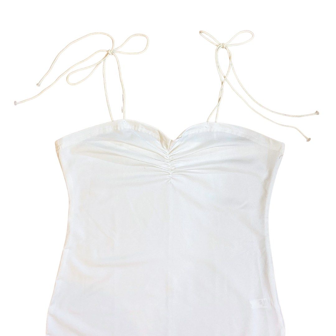 SHEIN White Tie Shoulder Ruched Cami Bodysuit (Category: Sleeveless) located in Cainta. Submitted by dysnae (Listing ID 1244088613, Image 2). Description: SHEIN White Ruched Tie Shoulder Strap Semi Sweetheart Neckline Bodysuit in Size Small/Medium * size S * but would better fit a size M * originally ₱250+ * never worn * very stretchy and comfy top 🤍 * rfs : super cute but its too big on me :(( don’t hesitate to message if u want more pics & inf