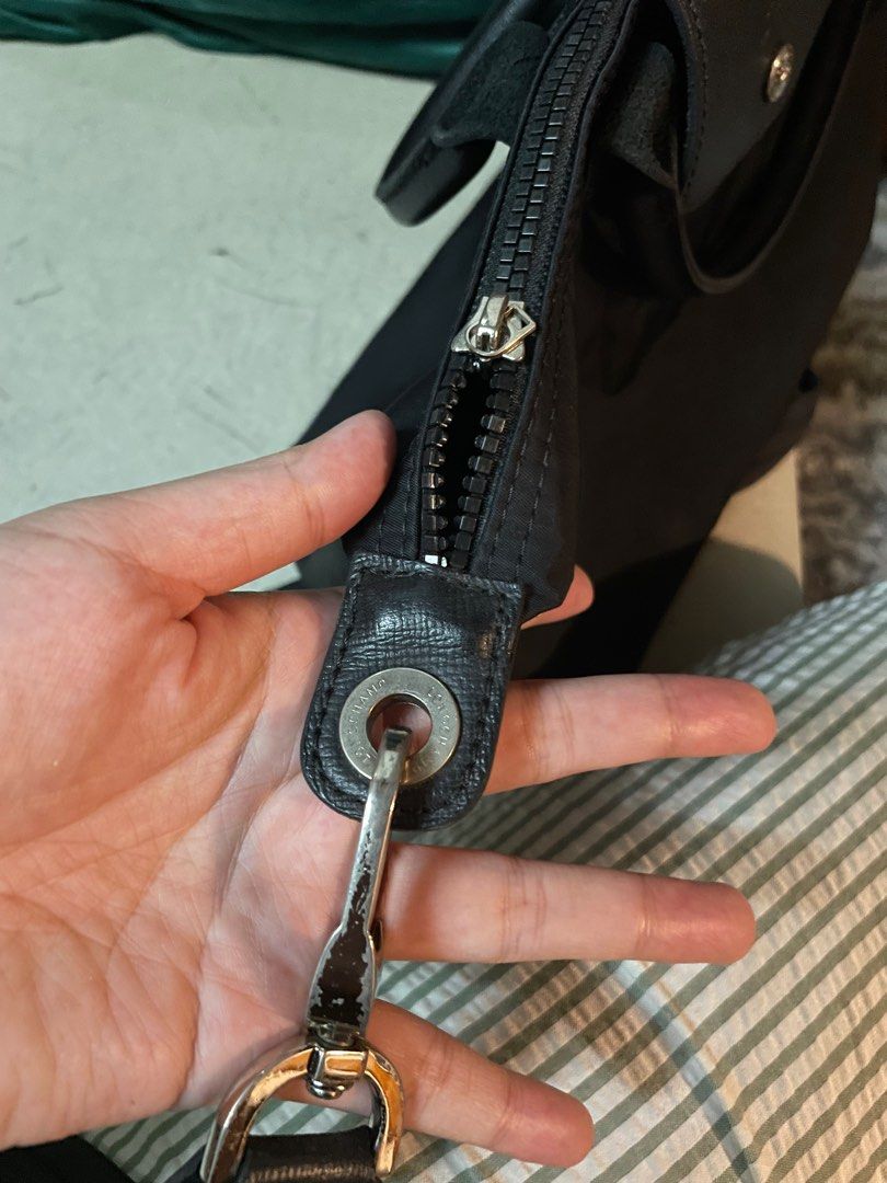 ORIGINAL Longchamp Black Small (Category: Luxury Bags & Wallets) located in Taguig. Submitted by ij_dh (Listing ID 1244385580, Image 3). Description: - Longchamp bought as a gift in 2017 - Well used throughout college - ORIGINAL! With signs of use and zipper w/ longchamp metal logo detached - Has bubbles already :( - RFS: Decluttering.