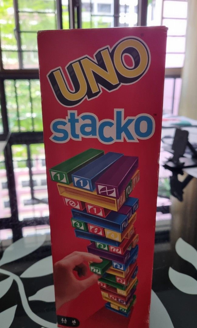 Uno Stacko (Category: Board Games & Puzzles) located in Singapore. Submitted by shulu (Listing ID 1244461448, Image 2). Description: rarely played but not suitable as a gift as there's a tear on box flap. not for fussy buyers. self collect at blk 219b bedok central.
