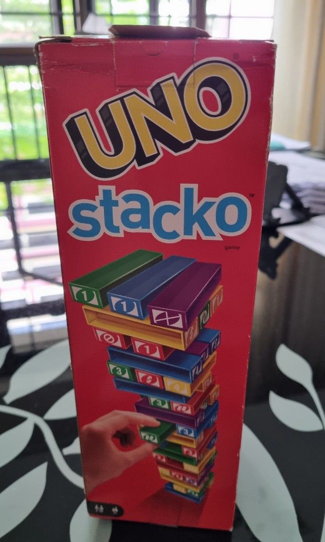 Uno Stacko (Category: Board Games & Puzzles) located in Singapore. Submitted by shulu (Listing ID 1244461448, Image 1). Description: rarely played but not suitable as a gift as there's a tear on box flap. not for fussy buyers. self collect at blk 219b bedok central.