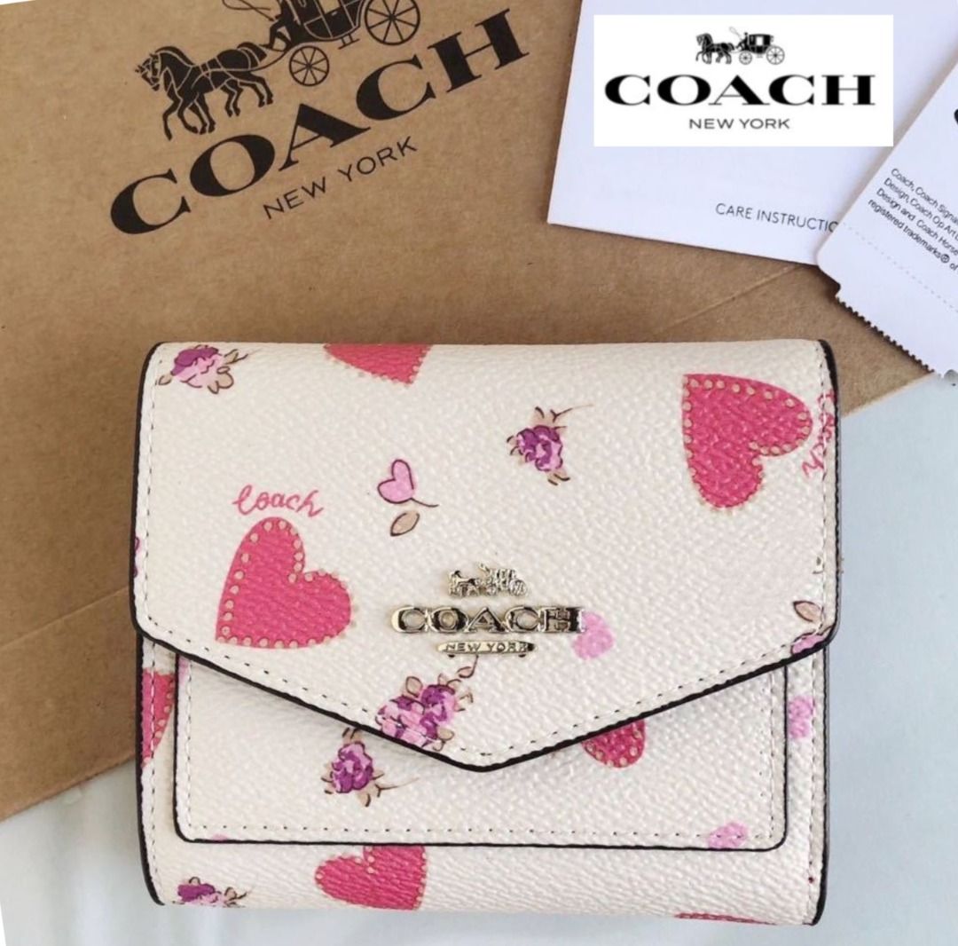 Buy the Coach Heart Print Small Wristlet Pink