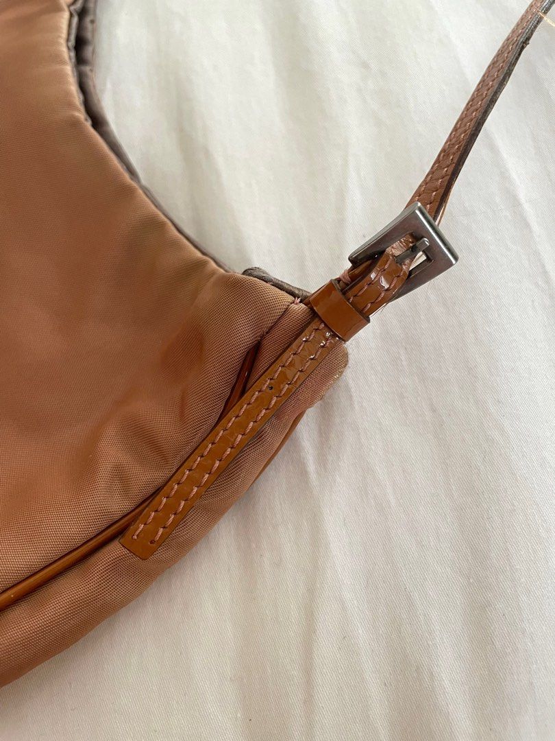 PRADA Copper Tessuto Nylon Shoulder Bag (Category: Luxury Bags & Wallets) located in Paranaque City. Submitted by denise__99 (Listing ID 1244722311, Image 3). Description: Authentic Prada Copper Tessuto Nylon Shoulder Bag Straps and inside silk lining are in good condition Just the right size for nightouts! RFS: Decluttering.