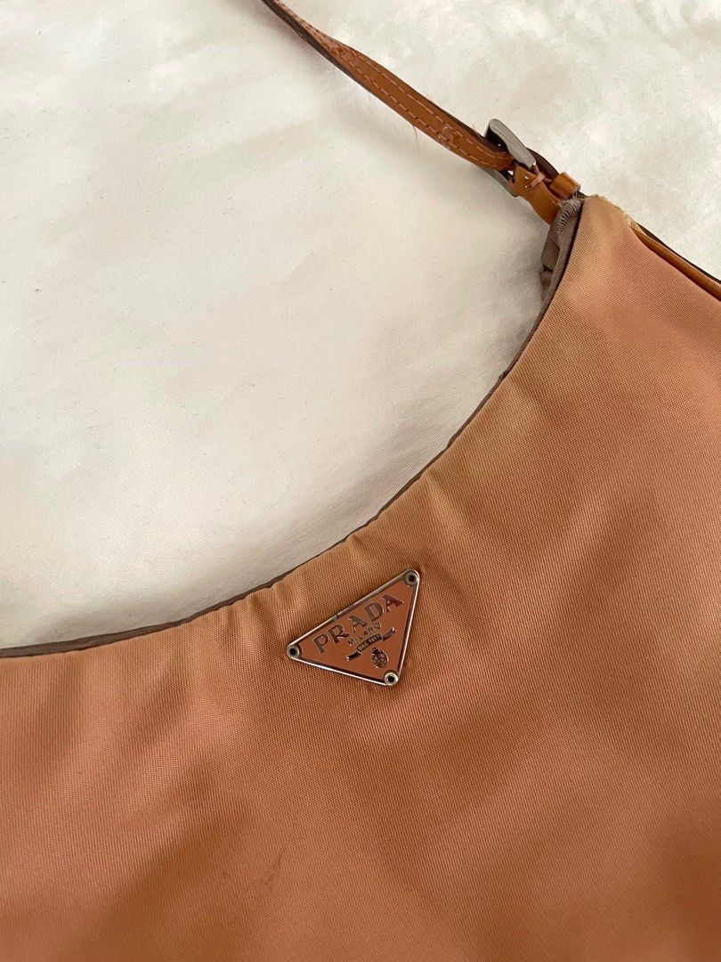 PRADA Copper Tessuto Nylon Shoulder Bag (Category: Luxury Bags & Wallets) located in Paranaque City. Submitted by denise__99 (Listing ID 1244722311, Image 2). Description: Authentic Prada Copper Tessuto Nylon Shoulder Bag Straps and inside silk lining are in good condition Just the right size for nightouts! RFS: Decluttering.