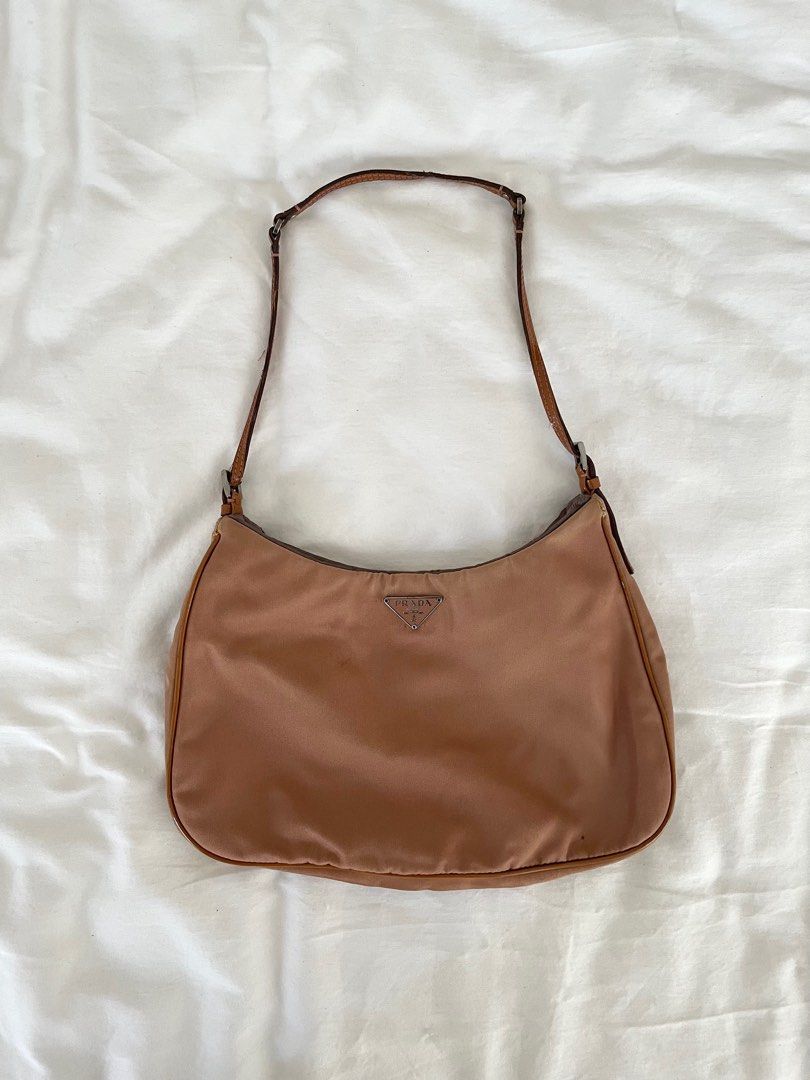 PRADA Copper Tessuto Nylon Shoulder Bag (Category: Luxury Bags & Wallets) located in Paranaque City. Submitted by denise__99 (Listing ID 1244722311, Image 1). Description: Authentic Prada Copper Tessuto Nylon Shoulder Bag Straps and inside silk lining are in good condition Just the right size for nightouts! RFS: Decluttering.