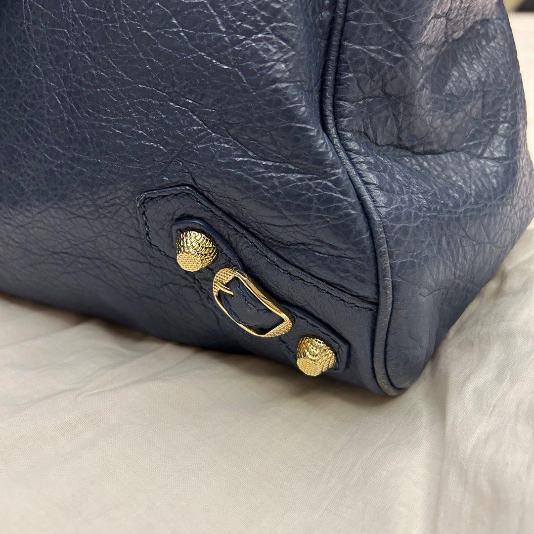 Balenciaga Classic City Bag (Category: Luxury Bags & Wallets) located in Quezon City. Submitted by bray_ (Listing ID 1244941675, Image 2). Description: Blue leather with gold-tone studs Very good condition With authenticity card and dust bag W 36 H 24 D 14 cm Handle drop 12cm Shoulder strap 26cm removable.