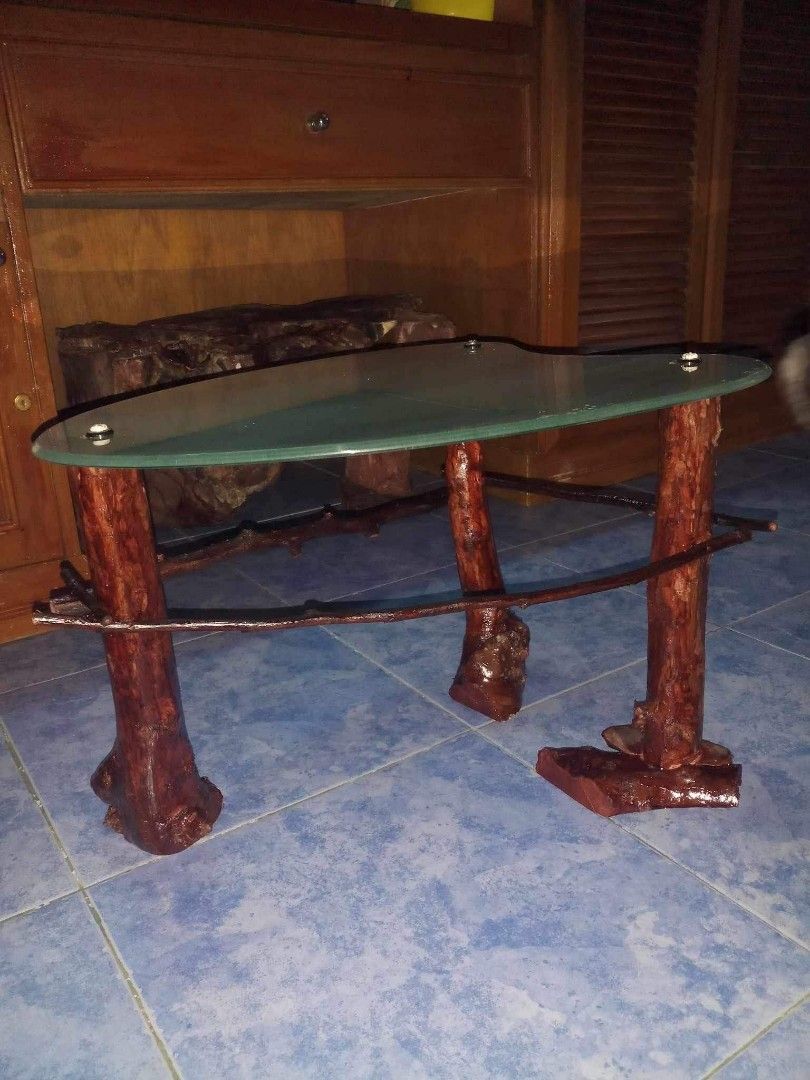 Bedside Table (Category: Tables & Sets) located in Quezon City. Submitted by marah19 (Listing ID 1244995673, Image 3). Description: Bedside table/corner table Materials: Top: Frosted glass, 5 mm thickness Table legs: Bayabas trunk. Finished with mahogany varnish. Dimensions: L 18.5” (irregular shape, measured at top diameter) H 14”.