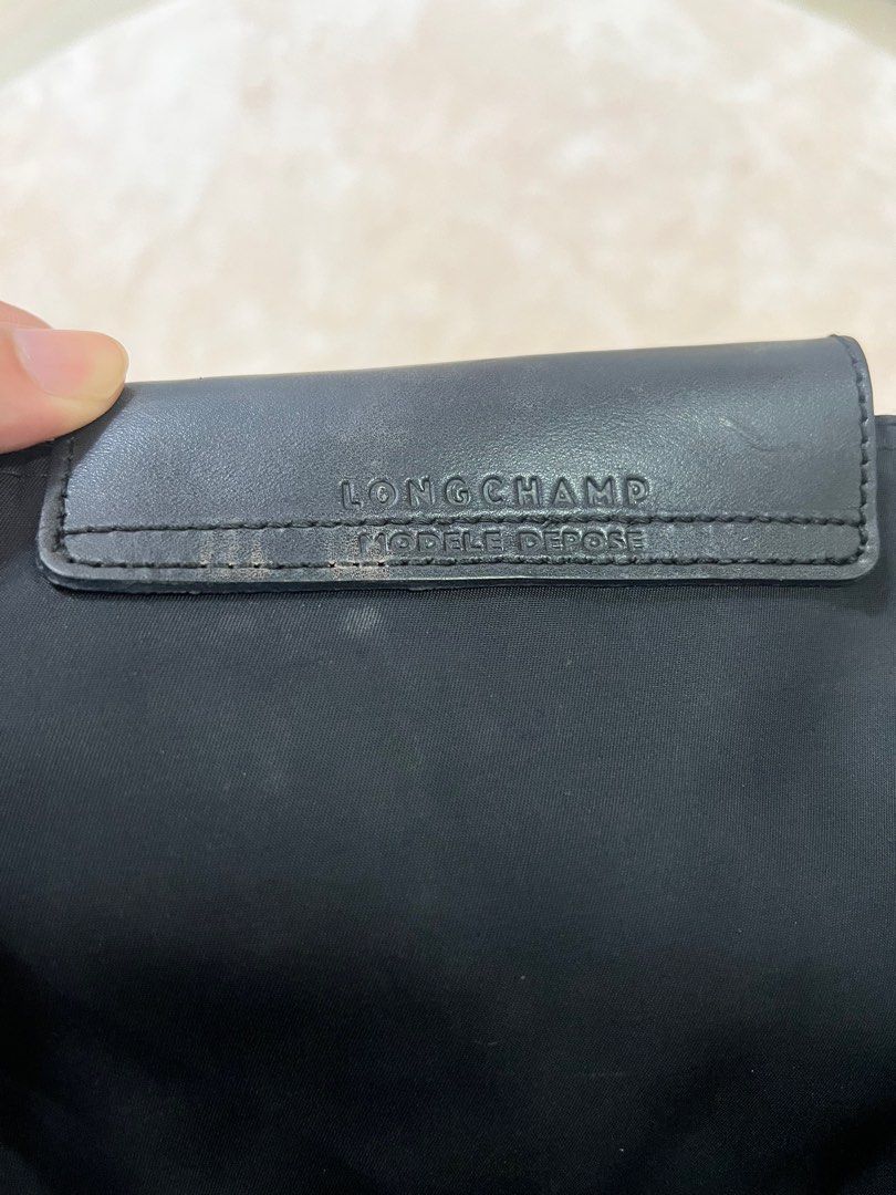Long Champ Never Full bag (Category: Luxury Bags & Wallets) located in Quezon City. Submitted by mendezcha68020 (Listing ID 1244887059, Image 2). Description: Authentic Long Champ Bag, with leather black logo design in front. Brought at Duty Free, selling at 2k. Issues: small negligible and repairable tan stains above and below (please see pictures). Please manage expectations. .