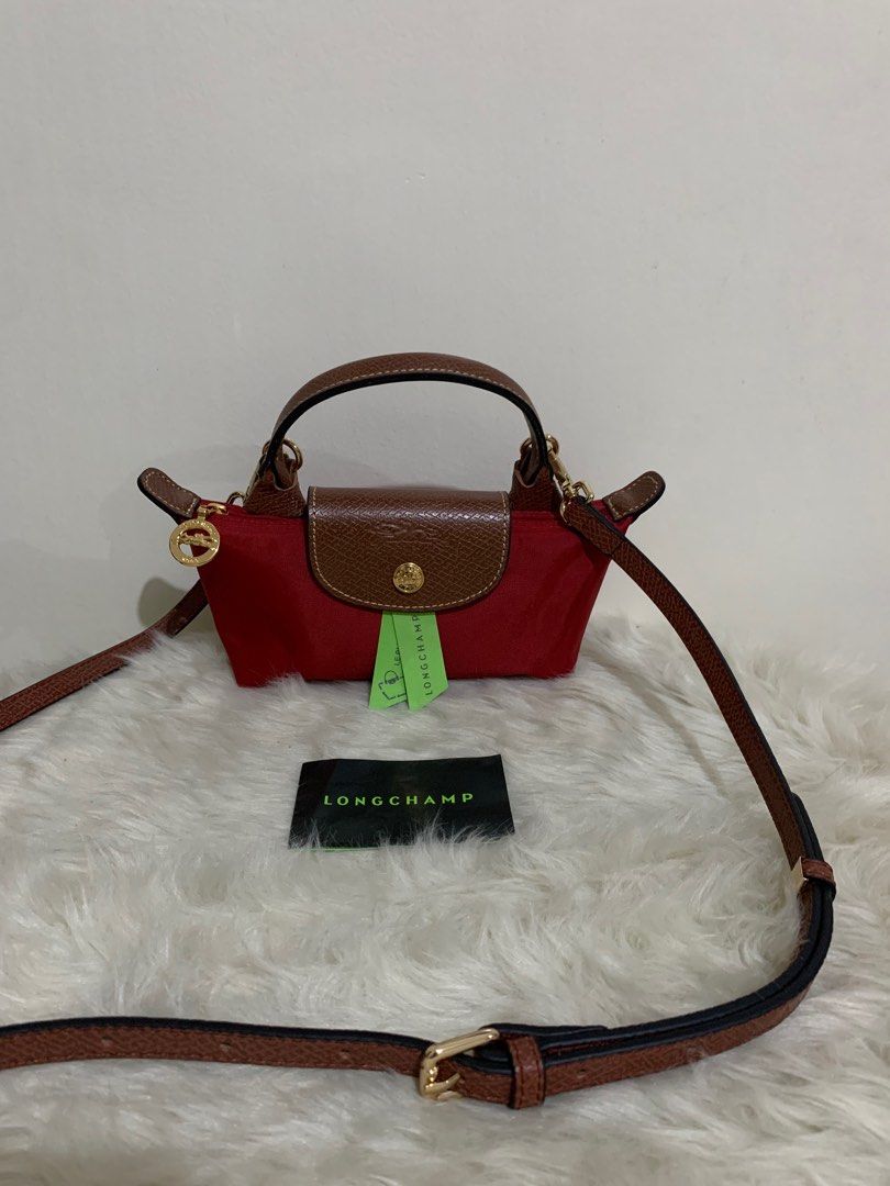 original longchamp mini pouch with sling (Category: Luxury Bags & Wallets) located in Cabuyao City. Submitted by luxbymishy (Listing ID 1245083262, Image 3). Description: authentic brand new complete inclusions .
