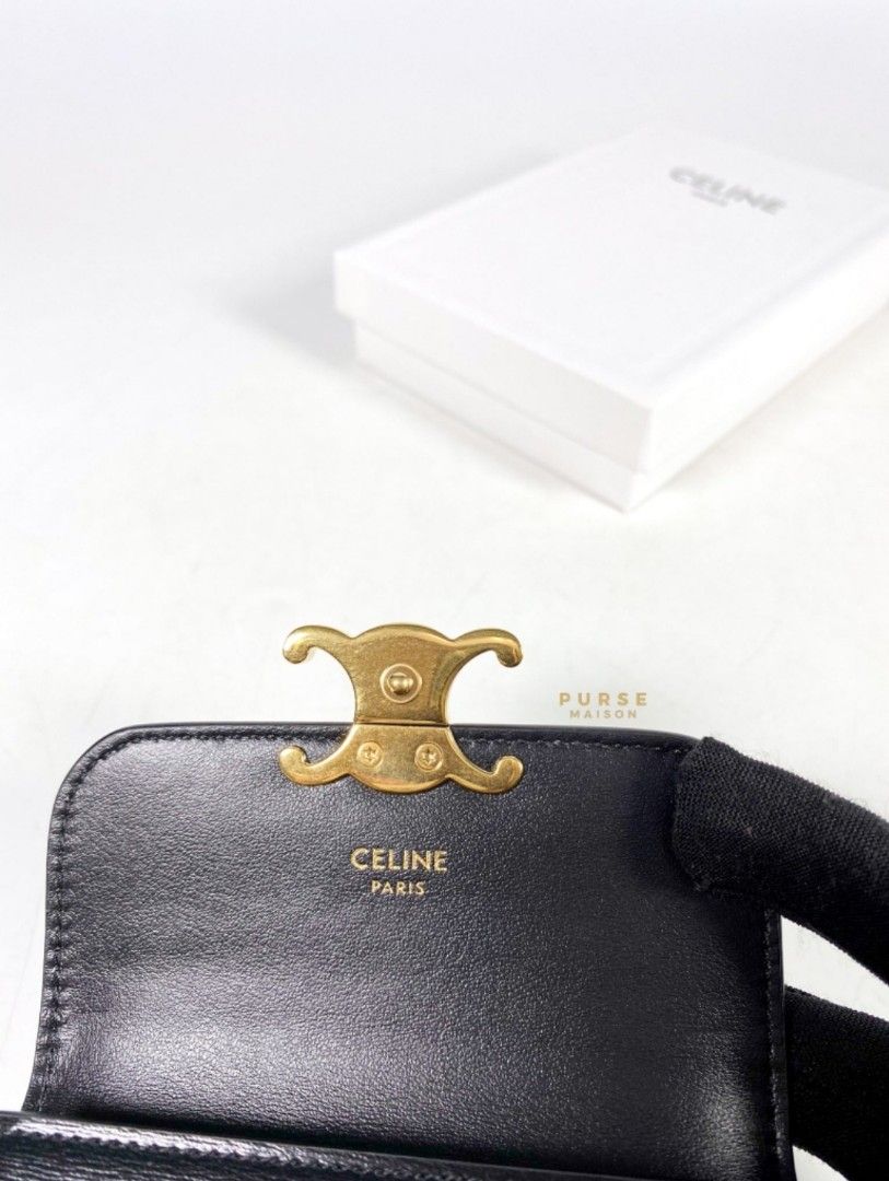 Shop CELINE Triomphe CARD HOLDER WITH FLAP TRIOMPHE IN SHINY CALFSKIN BLACK  by CHARIOTLONDON