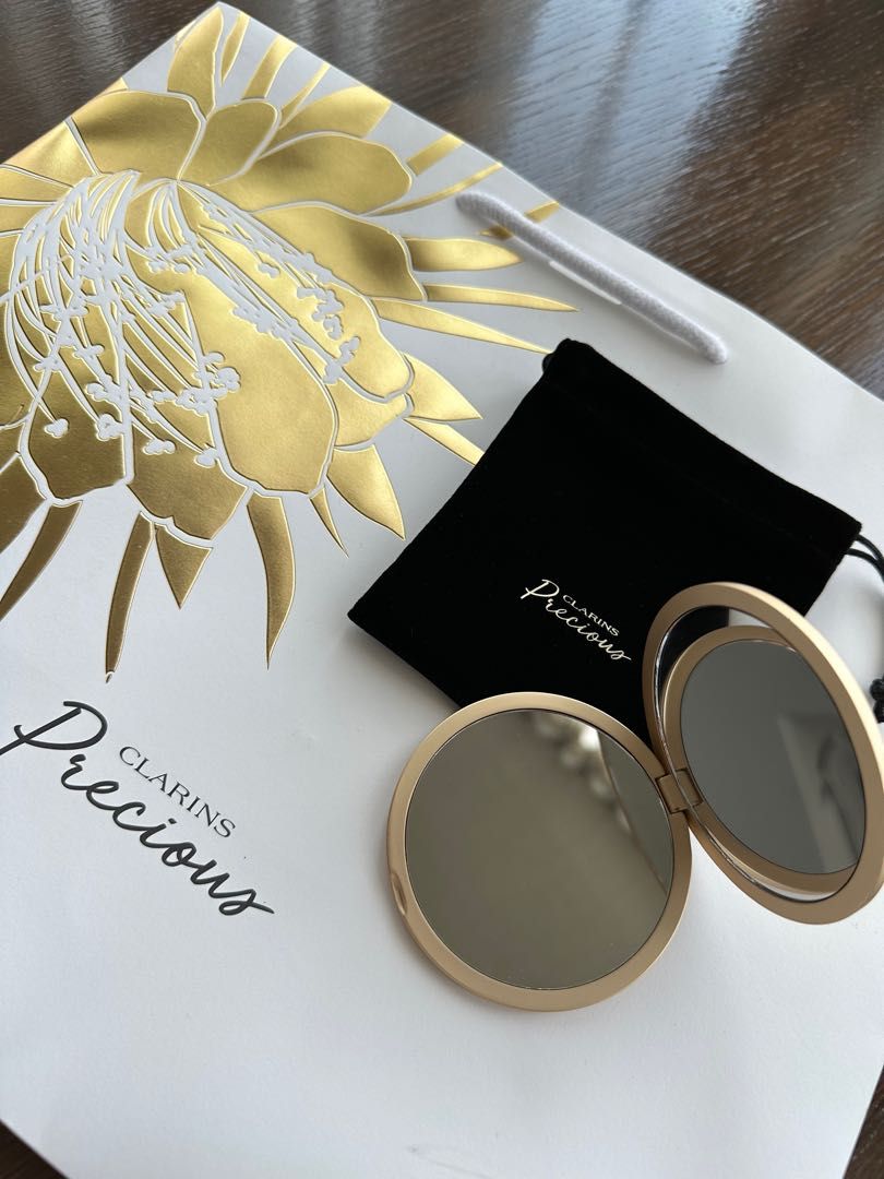 Clarins Precious Pocket Mirror (Category: Accessory holder, box & organizers) located in Singapore. Submitted by shoebidoo (Listing ID 1245326951, Image 2). Description: Clarins Precious Bag/Pocket Mirror 7.5cm diameter. 7mm thickness Matte gold finish. Comes with black velvet pouch as shown. Free tracked mail. No meet up. Payment via PayLah. No Caroupay. .