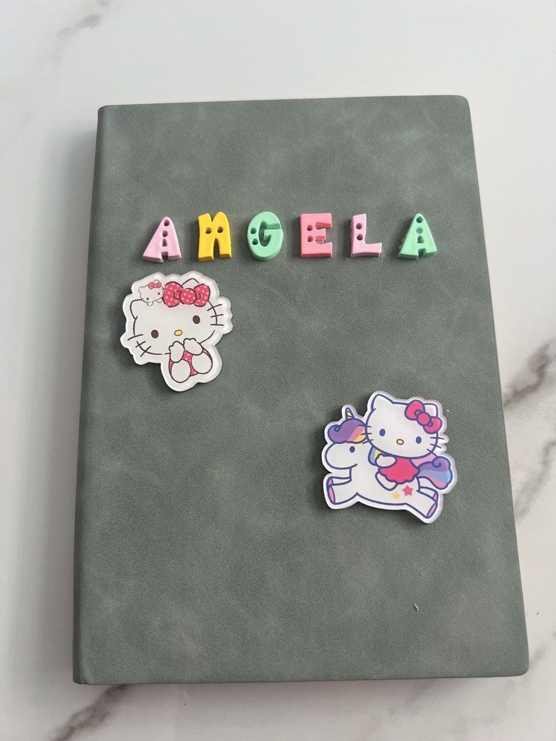 Customised notebook (Category: Stationery & School Supplies) located in Singapore. Submitted by peggylee05 (Listing ID 1245238446, Image 4). Description: Preparing what to get for teacher day present? 1. Choose your notebook colour 2. Choose your charm 3. Do DM us for colour of the notebook, name and charm. A5 : $11.90 B5: $14.90 PS: COLOUR ARE SUBJECTED TO DIFFERENCES DUE TO LIGHTING, Eg. Under the sunlight, under the light and etc..