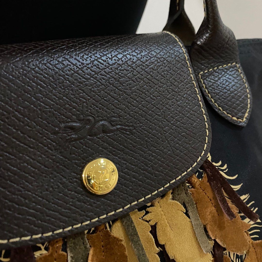 Longchamp Le Pliage Black Color 3D Apache Feather Bag (Category: Shoulder Bags) located in Taguig. Submitted by blackcaat (Listing ID 1245635129, Image 3). Description: Description: A charming feather design and classic construction lend added interest to this black nylon tote by Longchamp. With double top leather handles, this bag is finished with a Longchamp logo zipper. Product Condition: It is well used, overall it’s in a good condition Mater
