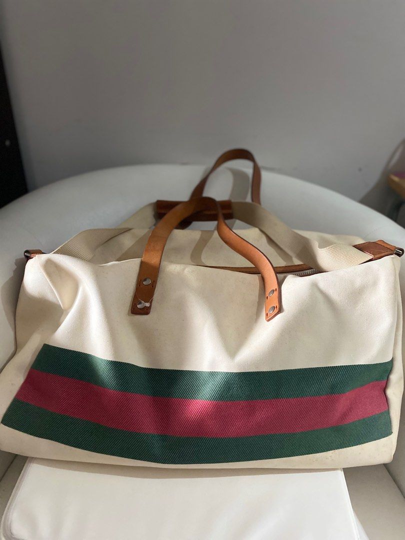 Authentic Gucci White GG Duffle Bag (Category: Luxury Bags & Wallets) located in Paranaque City. Submitted by french21closet (Listing ID 1245908594, Image 2). Description: Authentic Gucci cherryline White Duffel Bag Thick canvass linen with leather strap “Please expect sign of usage and manage your expectations” For serious takers only PM me if interested: 0917-4506853.