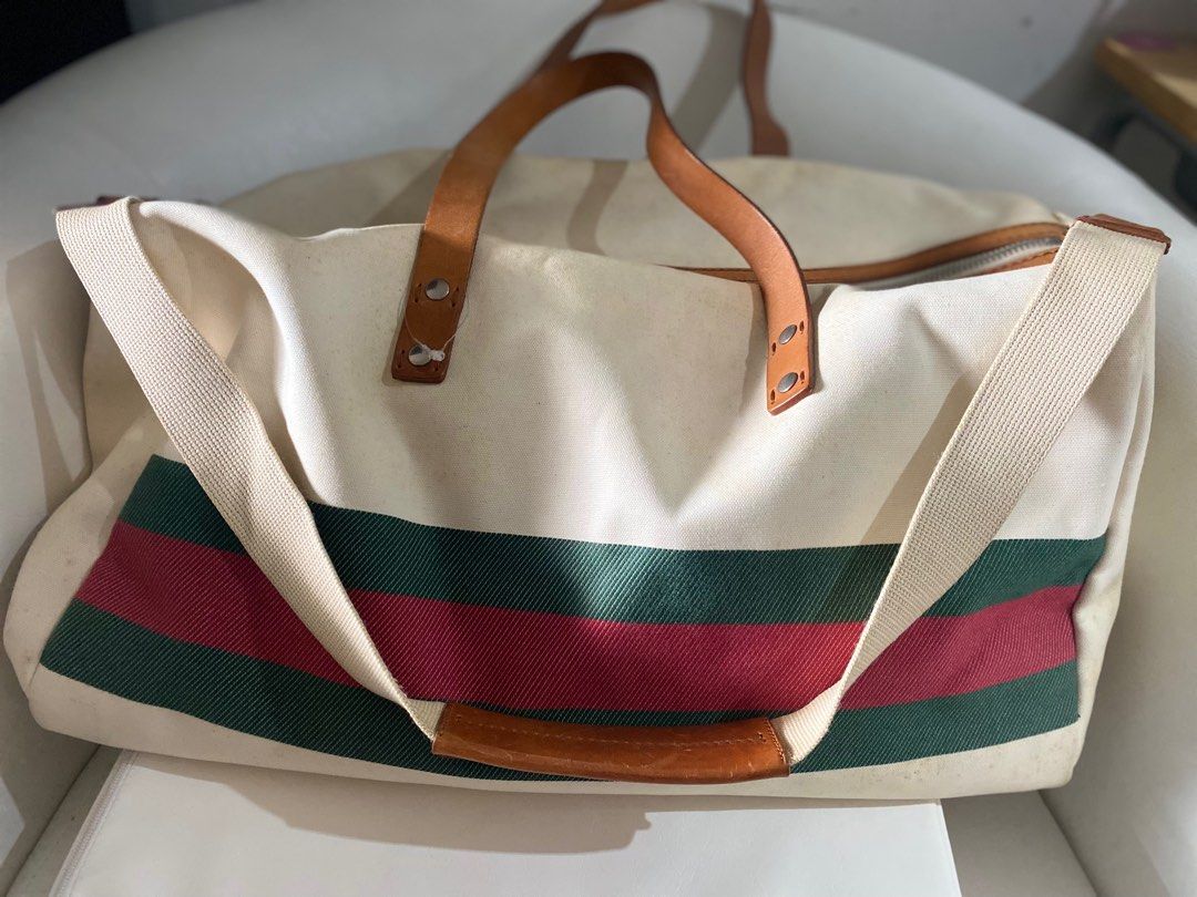 Authentic Gucci White GG Duffle Bag (Category: Luxury Bags & Wallets) located in Paranaque City. Submitted by french21closet (Listing ID 1245908594, Image 1). Description: Authentic Gucci cherryline White Duffel Bag Thick canvass linen with leather strap “Please expect sign of usage and manage your expectations” For serious takers only PM me if interested: 0917-4506853.