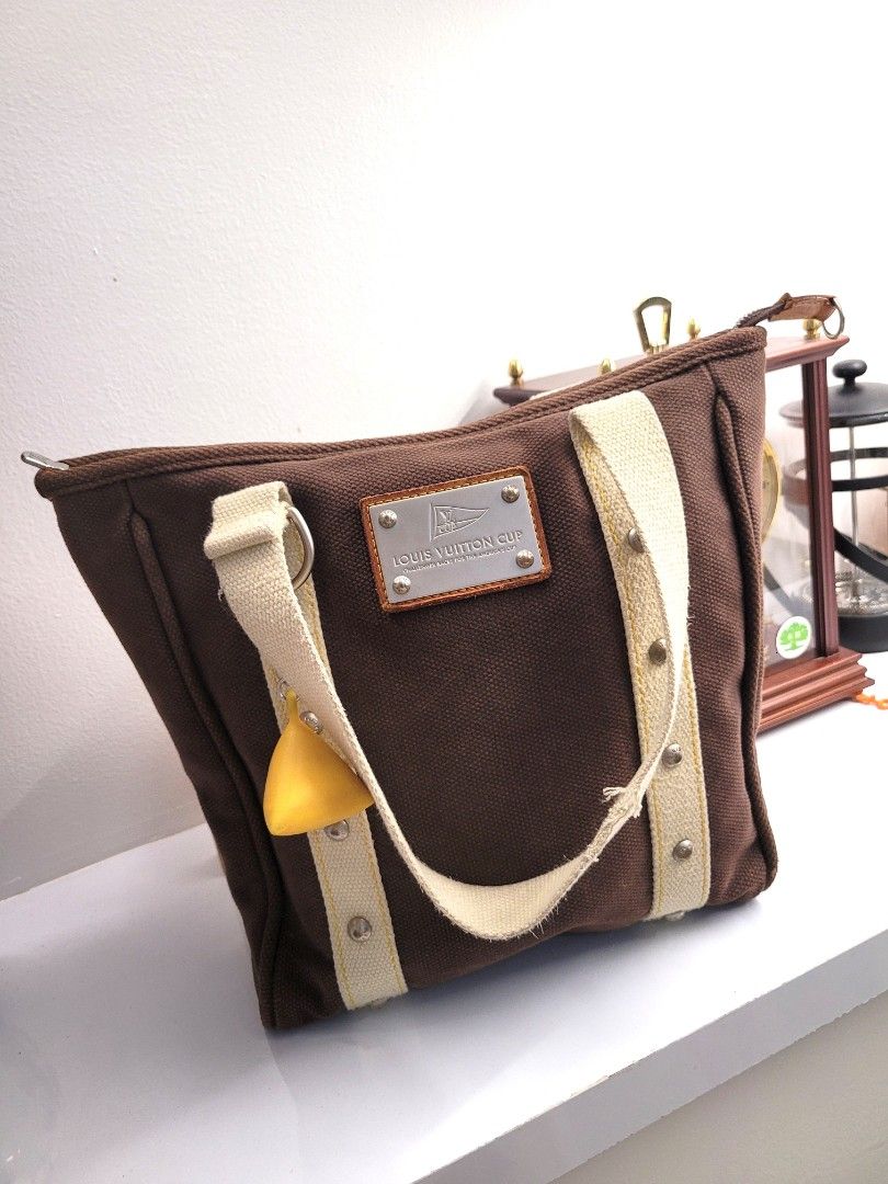 Authentic LV Louis Vuitton Cup Tote MM (Category: Luxury Bags & Wallets) located in Antipolo. Submitted by dlolin (Listing ID 1245912263, Image 1). Description: 💯 Legit. Money back if proven fake Charm palang magkano na so win win. Minor flaw on strap.