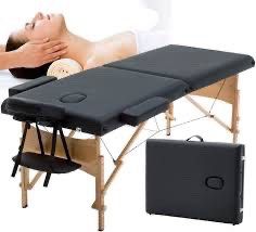 Black massage table with wooden legs