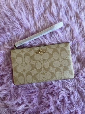 Coach wristlet (Category: Luxury Bags & Wallets) located in Mandaluyong City. Submitted by pheewz07 (Listing ID 1245928113, Image 1). Description: BRAND NEW COACH SIGNATURE WRISTLET PVC LARGE SIZE LIGHT KHAKI - ROSE WITH TAG AND CARECARD NO PAPERBAG PLEASE SEE ACTUAL PHOTOS FOR REFERENCE BOUGHT IN US RFS: decluttering FIXED PRICE - NO HAGGLING.