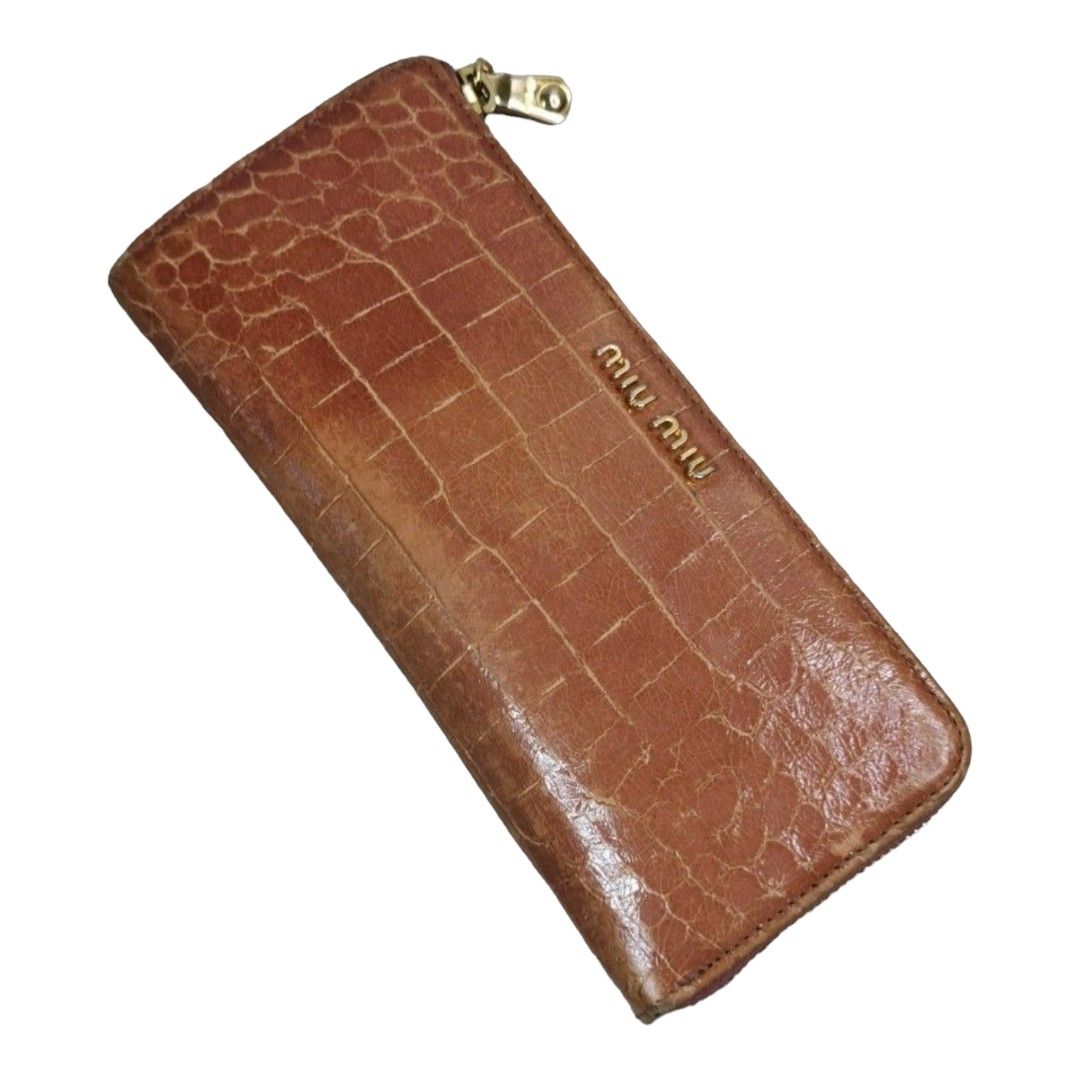 authentic miu miu slim zippy wallet (Category: Luxury Bags & Wallets) located in Quezon City. Submitted by manerarestorationservices (Listing ID 1208566348, Image 1). Description: SALE SALE SALE❗❗❗ Money back Guarantee 💯% Gauranteed authentic MIUMIU Slim zippy wallet *Color: brown orange croc skin *Size: long slim *Condition: 8/10 never been spa -Used * Inclusions: wallet only Rank review by the criterion of our shop about the products condition