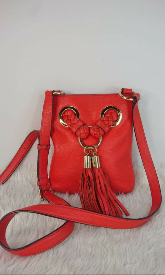 Authentic Michael Kors red orange sling crossbody bag (Category: Luxury Bags & Wallets) located in San Pablo. Submitted by jess_tw_carpena (Listing ID 1241366111, Image 1). Description: mint condition (almost new) with dustbag personal ratings: 9/10.