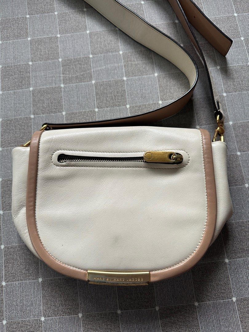 Marc Jacobs leather crossbody bag cream (Category: Cross-body Bags) located in Manila. Submitted by skyprincess (Listing ID 1241621391, Image 2). Description: Leather in good condition Slight flaw on gold handles as seen in photo (barely noticeable when used).