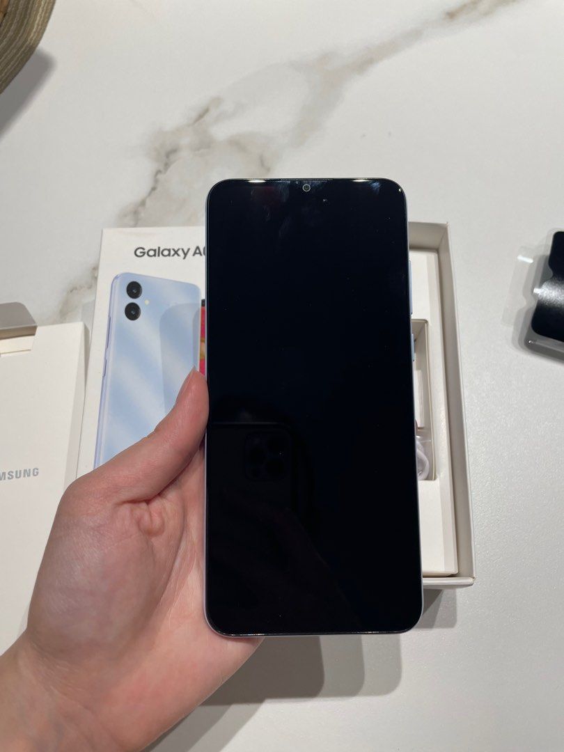 Samsung Galaxy A04E light blue 32GB (Category: Samsung) located in Pasig City. Submitted by lexnthecity (Listing ID 1241661084, Image 3). Description: 32GB Brand new, never used/opened, no flaws, comes in original box and packaging. Smart sim only .