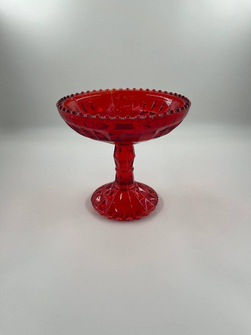 Ruby Compote Glass (Category: Vases & Decorative Bowls) located in Singapore. Submitted by hyggenseek (Listing ID 1241852033, Image 1). Description: <Ruby Red Footed Compote Glass> Here are 2 compote dishes by Jeanette Glass Co. These are 1940’s and Ruby Red. These are the Windsor Pattern with the beaded edges on the top and bottom plus the diamond cut pattern. Perfect as offering bowls or fruit bowls. Item in good condition apart from some age s