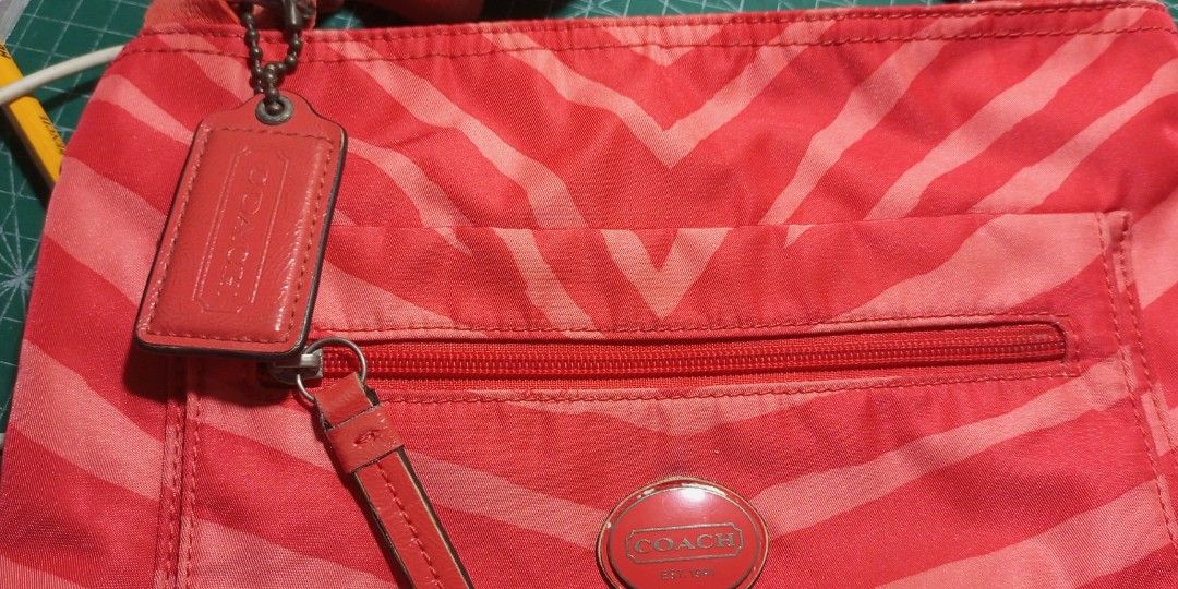 Coach crossbody bag (Category: Luxury Bags & Wallets) located in Manila. Submitted by myitemsarepreloved (Listing ID 1242016523, Image 2). Description: Coach Nylon Crossbody bag minimal flaws po ung crack Nung zipper pull clean inside and out with hangtag.