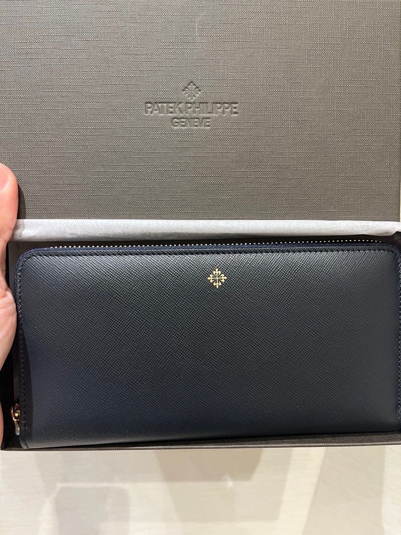PATEK PHILIPPE - Brown leather wallet. 7 x 8.5 x 2.5 cm.…
