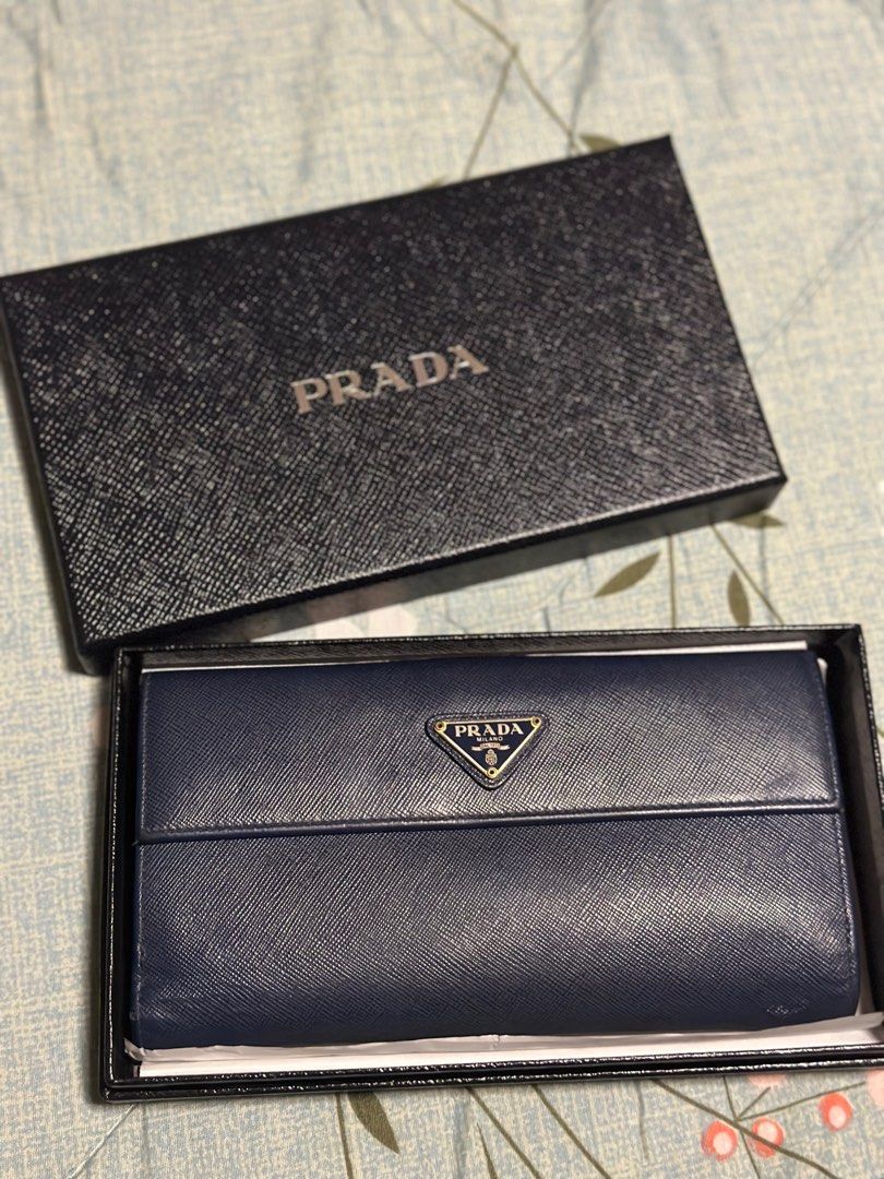 Prada Blue Saffiano Leather Flap Continental (Category: Luxury Bags & Wallets) located in Taguig. Submitted by johnhb (Listing ID 1242131189, Image 2). Description: Unsure buyers and lowballers will be reported to Carousell support and will be blocked forever Bought in Prada Greenbelt 5 - 2015 Lost care card, but with box. MOP: GCash MOD: Lalamove from BGC or meetup in Citi Plaza for inspection.
