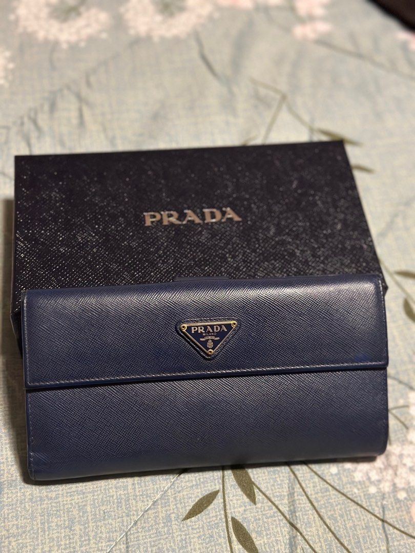 Prada Blue Saffiano Leather Flap Continental (Category: Luxury Bags & Wallets) located in Taguig. Submitted by johnhb (Listing ID 1242131189, Image 3). Description: Unsure buyers and lowballers will be reported to Carousell support and will be blocked forever Bought in Prada Greenbelt 5 - 2015 Lost care card, but with box. MOP: GCash MOD: Lalamove from BGC or meetup in Citi Plaza for inspection.