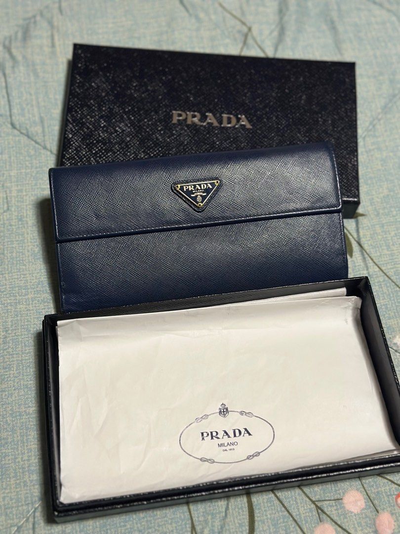 Prada Blue Saffiano Leather Flap Continental (Category: Luxury Bags & Wallets) located in Taguig. Submitted by johnhb (Listing ID 1242131189, Image 1). Description: Unsure buyers and lowballers will be reported to Carousell support and will be blocked forever Bought in Prada Greenbelt 5 - 2015 Lost care card, but with box. MOP: GCash MOD: Lalamove from BGC or meetup in Citi Plaza for inspection.