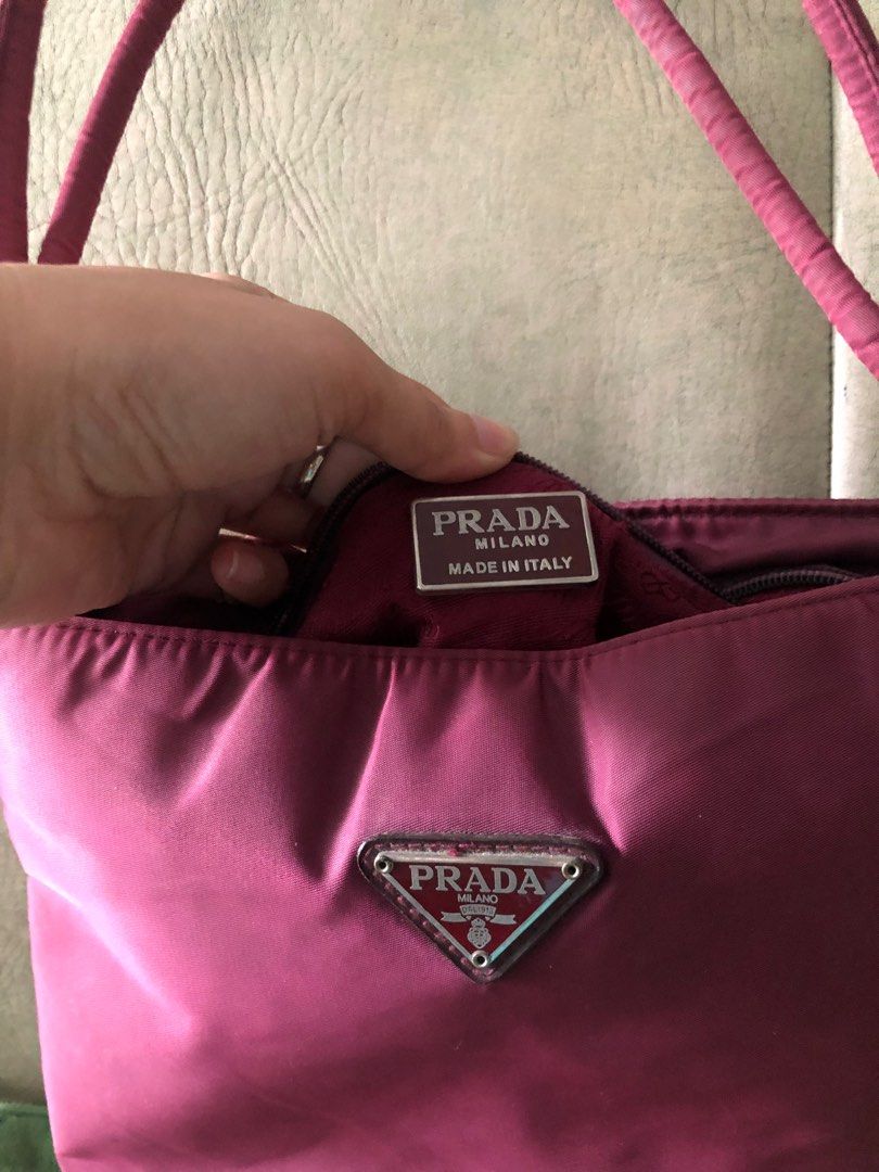 Preloved Vintage Prada nylon tessuto bag (Category: Luxury Bags & Wallets) located in Manila. Submitted by frugalfinds89 (Listing ID 1242062604, Image 3). Description: Preloved Prada Nylon tote hand/shoulder bag (NGA) from my mothers closet (vintage) Rare find with center zip compartment plus inside pocket Flaw: 1 zip puller detached but can be fixed with minimal sign of usage RFS: Decluttering/need funds NO RETURNS, NO EXCHANGE , NO REFUND!.