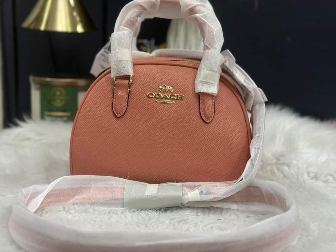 Coach (Category: Luxury Bags & Wallets) located in Cabanatuan. Submitted by Valeriecllctn (Listing ID 1248387490, Image 3). Description: Coach Sydney Satchel Leather light Coral ₱8, 300only Retail price: 350$ Super cute in actual 😍 Product Details Crossgrain leather Inside multifunction pocket Zip closure, fabric lining Handles with 2 3/4" drop Detachable strap with 22 1/2" drop for shoulder or crossbody wear 8" (L) x 6" (H) x 5" (W).