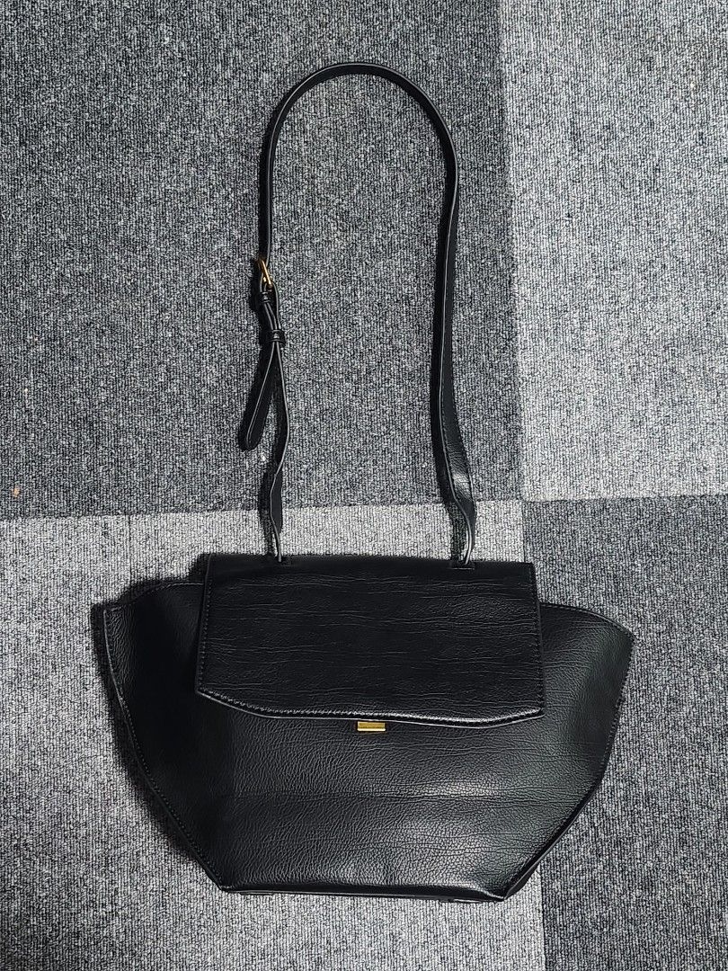 Charles and Keith Trapeze Top Handle Bag (Category: Shoulder Bags) located in Tarlac. Submitted by jemserrano (Listing ID 1249769711, Image 2). Description: Charles & Keith Trapeze Top Handle Bag • Black • Like new condition • Issue: Missing small handle, slight wrinkled long strap (see photos for reference) Dimensions: H - 9 inches L - 17 inches W - 4.5 inches ○ Shopee Checkout not available ○ Location📍 Tarlac ○ MOP: Gcash ○ Courier: J&T.