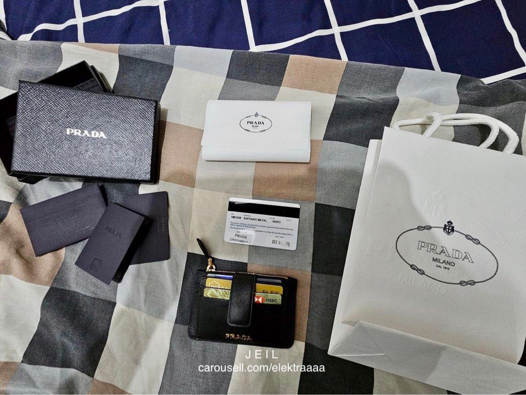 Prada Saffiano Leather Card Holder (Category: Luxury Bags & Wallets) located in Las Pinas. Submitted by elektraaaa (Listing ID 1249745494, Image 3). Description: 💥We can have it checked at Prada Greenbelt to verify authenticity :) Negotiate REASONABLY!😬 Prada 1MC038 QWA F0002 Saffiano Metal Oro Nero Compact and functional, the Saffiano leather credit card holder reveals elegant lines. Provided with a zipper pocket, the front has visible card sl
