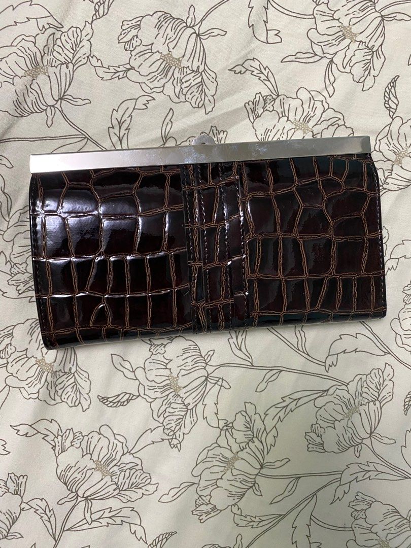 Faux leather brown wallet (Category: Wallets & Card holders) located in Quezon City. Submitted by RoxyB (Listing ID 1246697336, Image 2). Description: Faux leather wallet/card holder. Gifted. Never been used. In good condition. RFS: Decluttering .