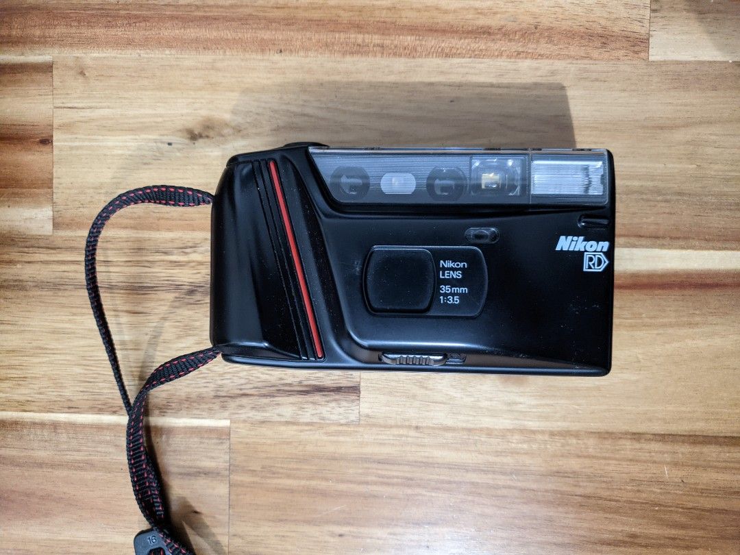 Nikon RD (Category: Cameras) located in Singapore. Submitted by quantom (Listing ID 1250168521, Image 1). Description: Helping my relative clear his old camera gear. Comes as shown in pictures. I've tried slotting in 2 AA batteries - the camera starts making a high pitch whine and seems to take a shot when I depress the shutter button (I don't have any film to test with though). However, I wasn't able to keep the battery bay shut - see last pic..