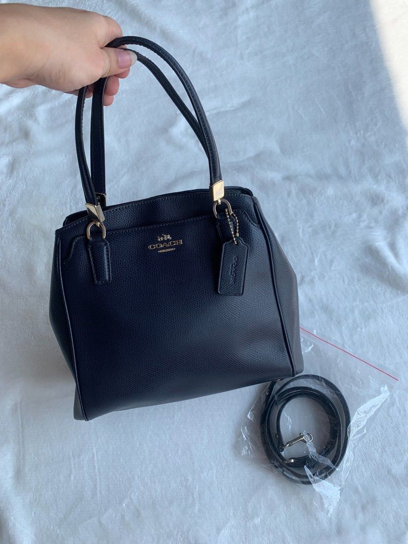 Coach Minetta Crossbody Bag (Category: Luxury Bags & Wallets) located in Samal. Submitted by camsydgm (Listing ID 1250198182, Image 2). Description: 🖤Original Coach Minetta Crossbody Bag - Navy Blue (Darker Shade) 🖤Hairlines on the hardware 🖤 No signs of usage inside (Never used) 🖤3 compartment (2 open pocket 1 zipper pocket) 🖤2 zipper pocket inside 🖤1 open pocket inside 🖤1 open pocket outside RFS: Not using anymore Price + Shipping Fee Sh